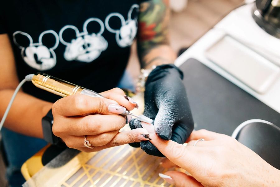 Thiara shaping a client set during a private nail appointment at TLC Nails and Esthetics in Nottingham, MD