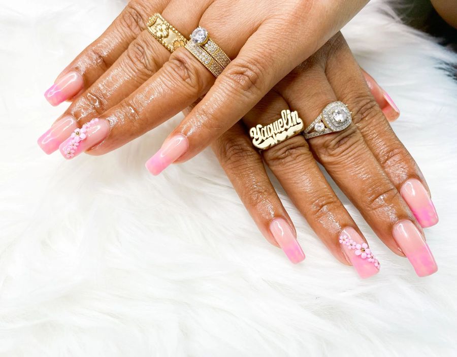 Long pink square nails with gold charm accents by TLC Nails and Esthetics in Nottingham, MD