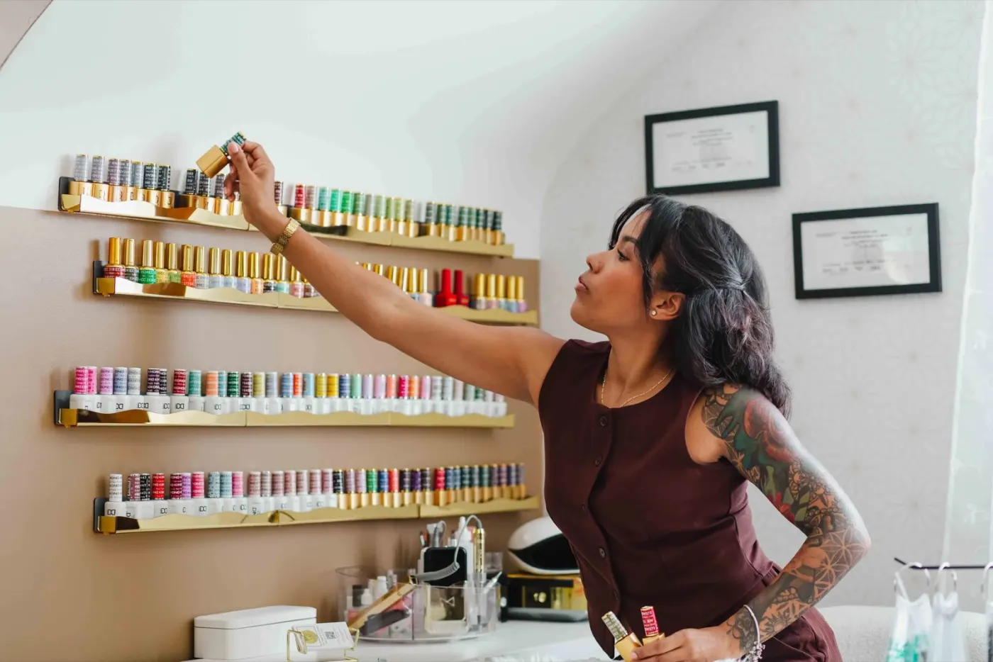 Thiara, licensed nail technician and esthetician, choosing a color in her private suite in Nottingham, MD